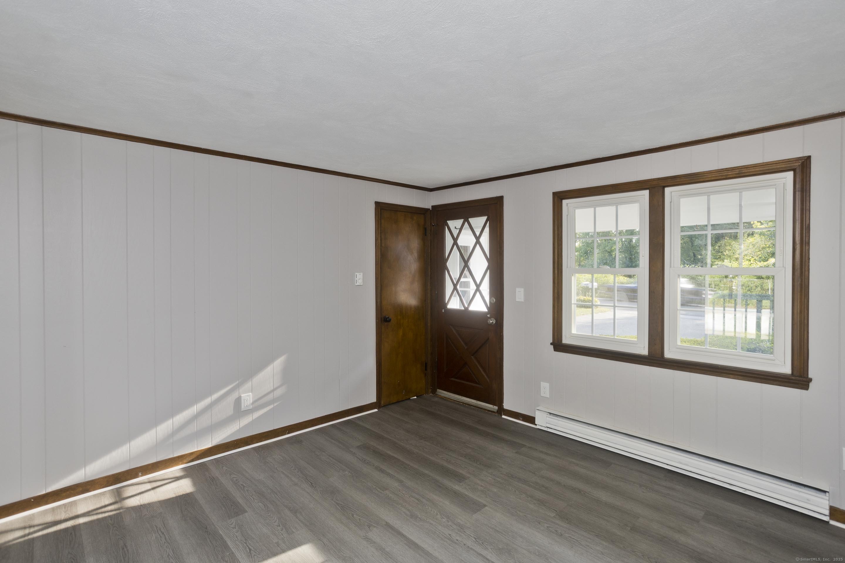 215 Sand Dam Road Thompson, CT 06277 - Photo 13 of 36 an empty room with wooden floor and windows