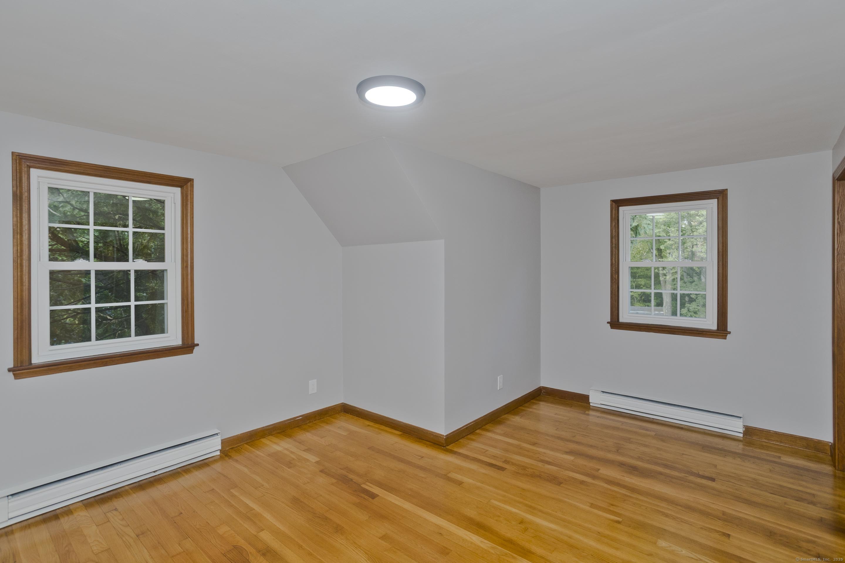 215 Sand Dam Road Thompson, CT 06277 - Photo 14 of 36 a view of empty room with wooden floor and fan