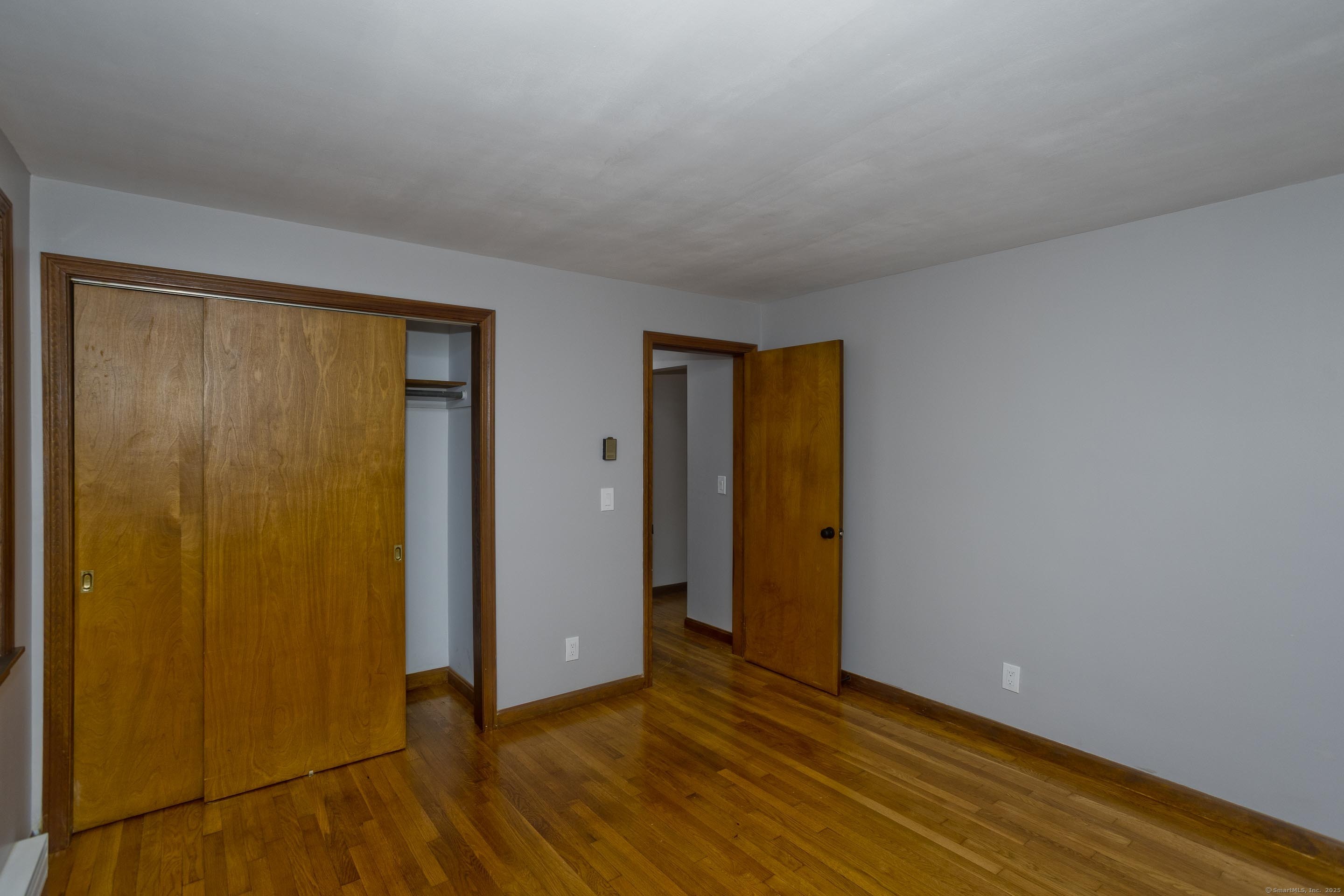 215 Sand Dam Road Thompson, CT 06277 - Photo 16 of 36 a view of an empty room with wooden floor and closet