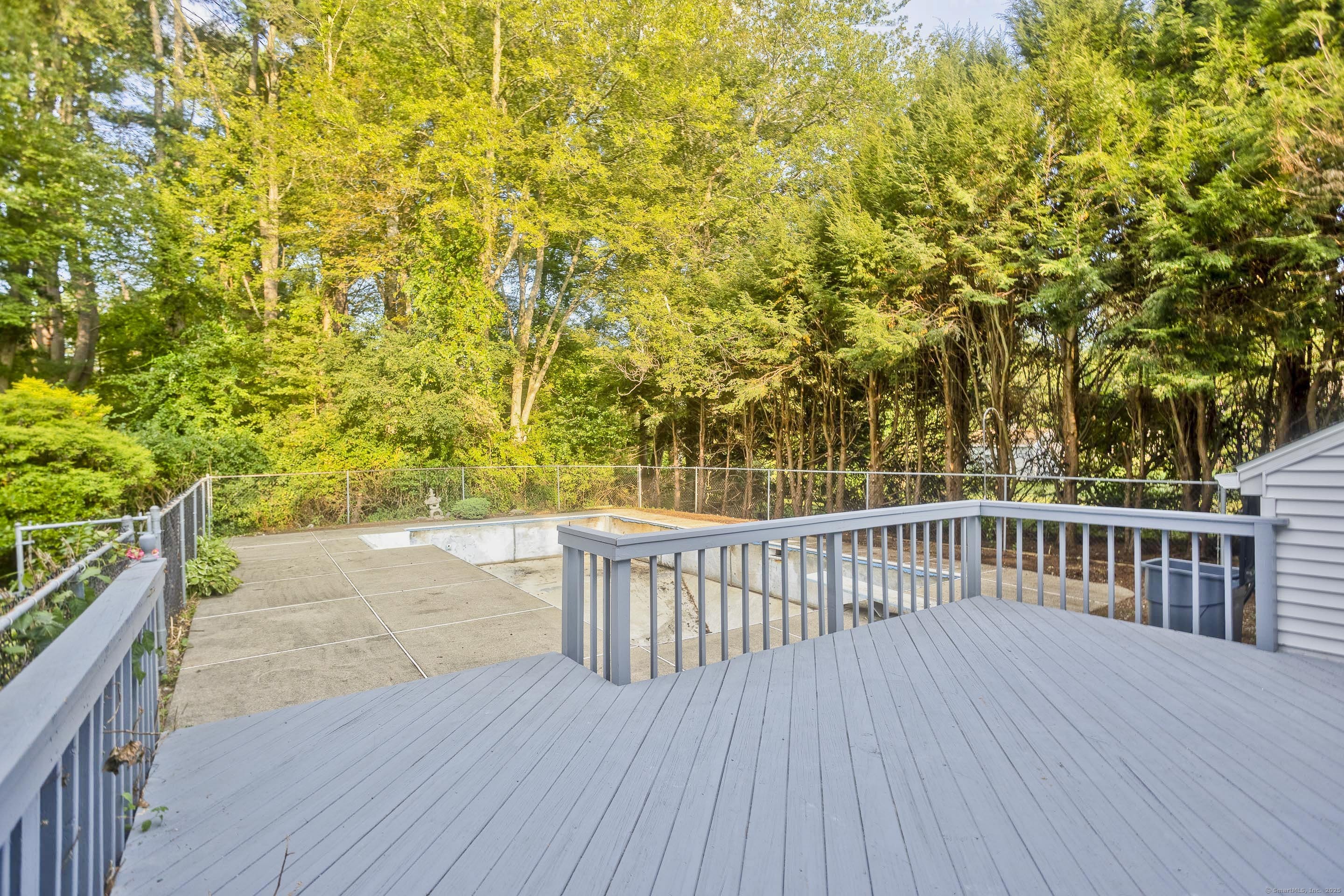 215 Sand Dam Road Thompson, CT 06277 - Photo 27 of 36 a balcony with wooden floor and fence