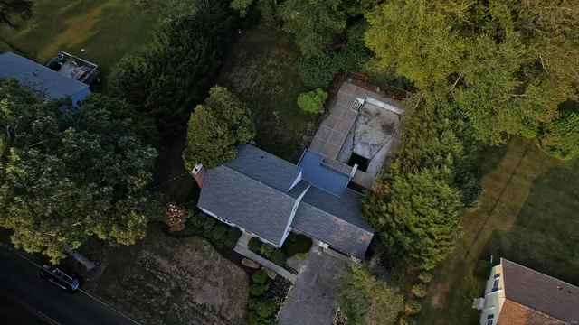 an aerial view of a house with garden space and street view