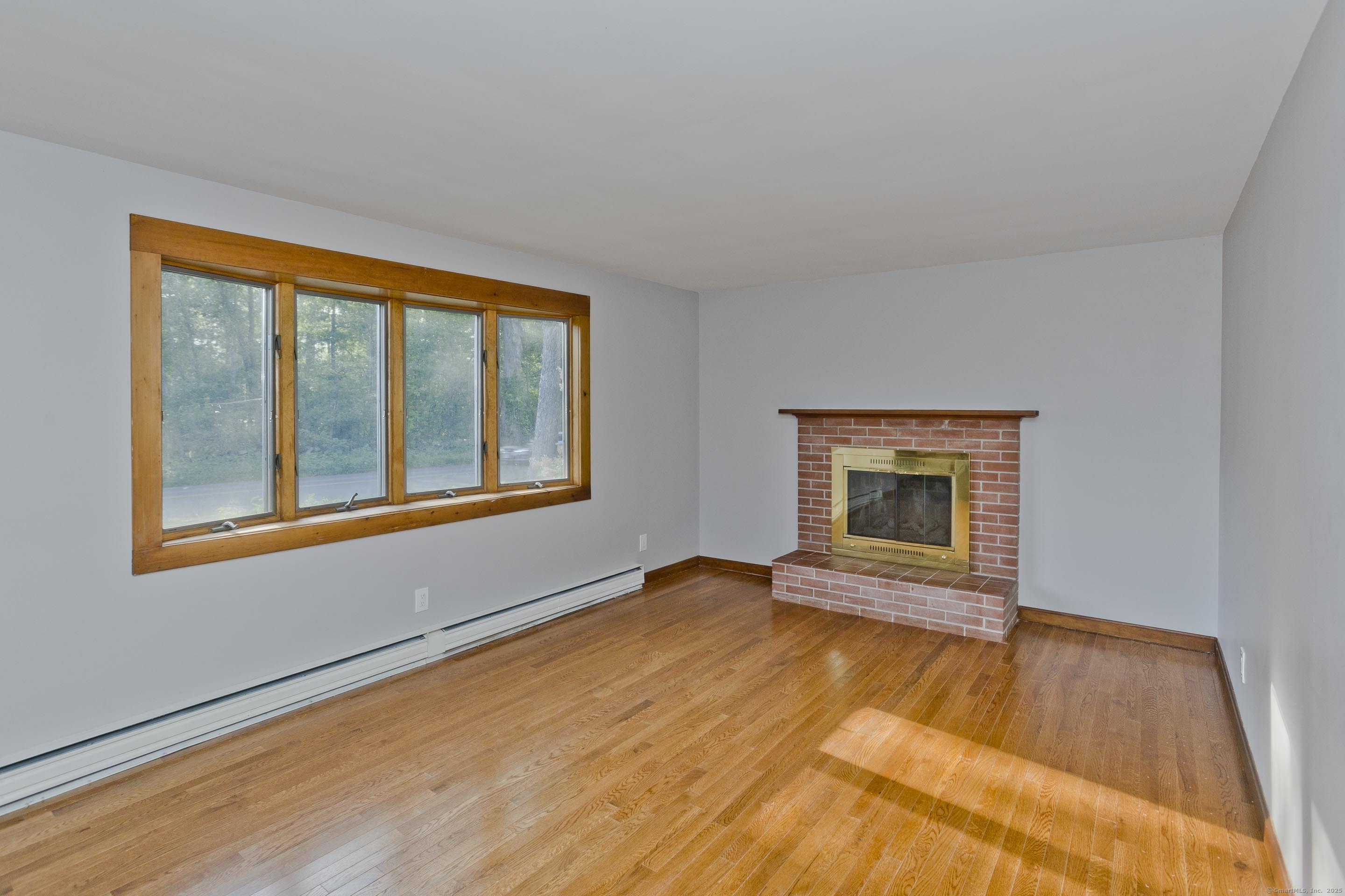 215 Sand Dam Road Thompson, CT 06277 - Photo 4 of 36 a view of an empty room with glass door and wooden floor
