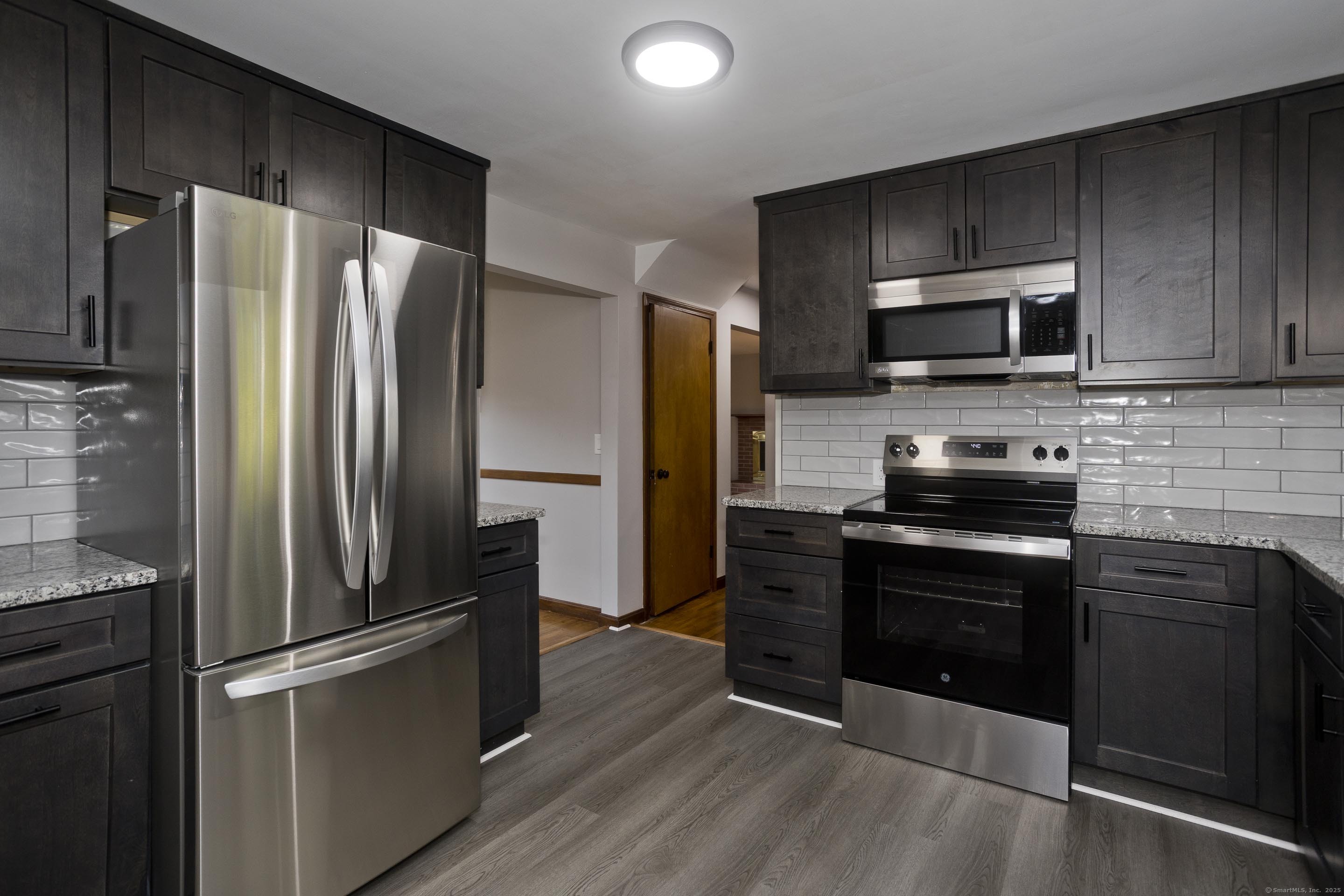 215 Sand Dam Road Thompson, CT 06277 - Photo 6 of 36 a kitchen with a refrigerator stove and microwave