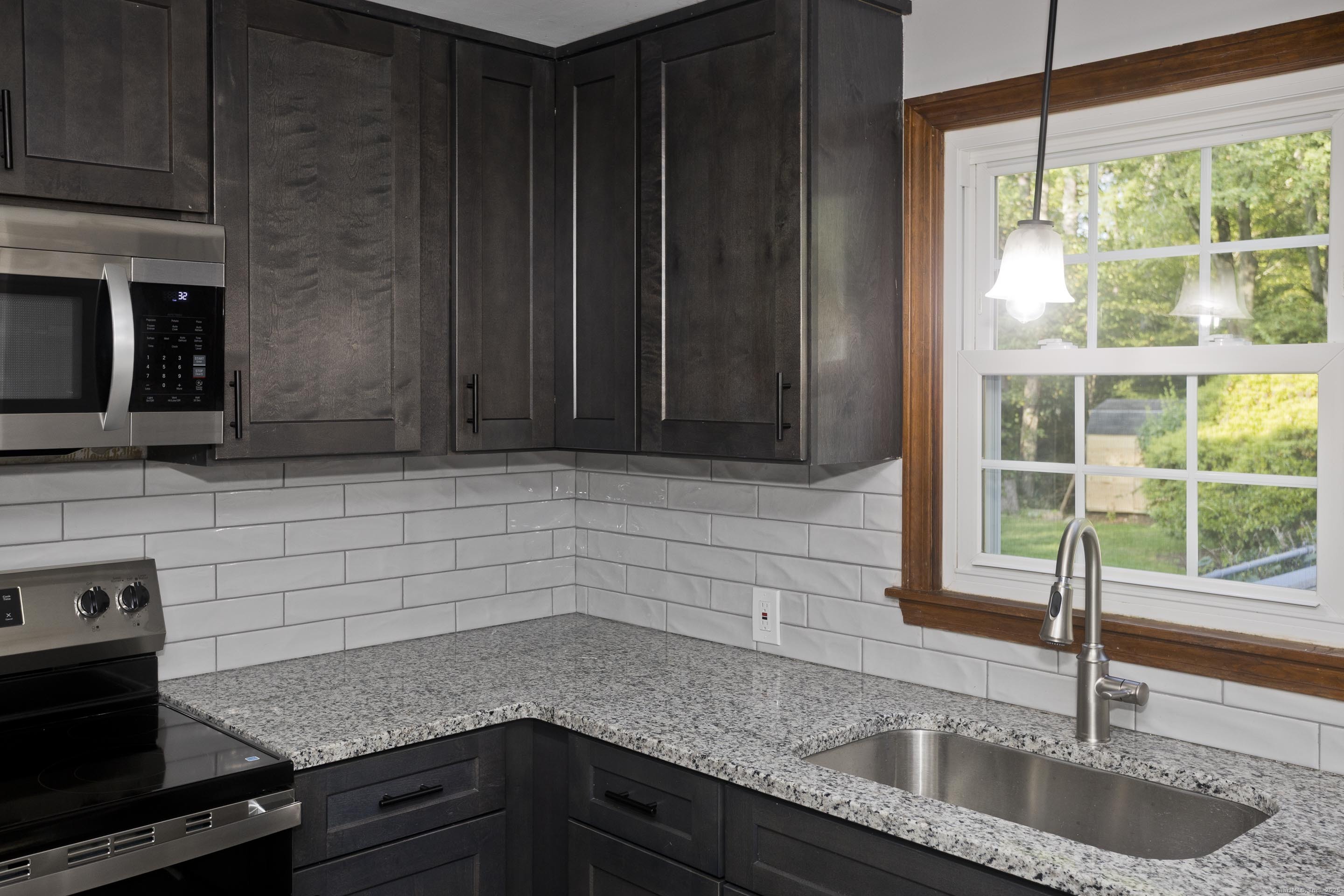 215 Sand Dam Road Thompson, CT 06277 - Photo 7 of 36 a kitchen with granite countertop a sink a stove and cabinets