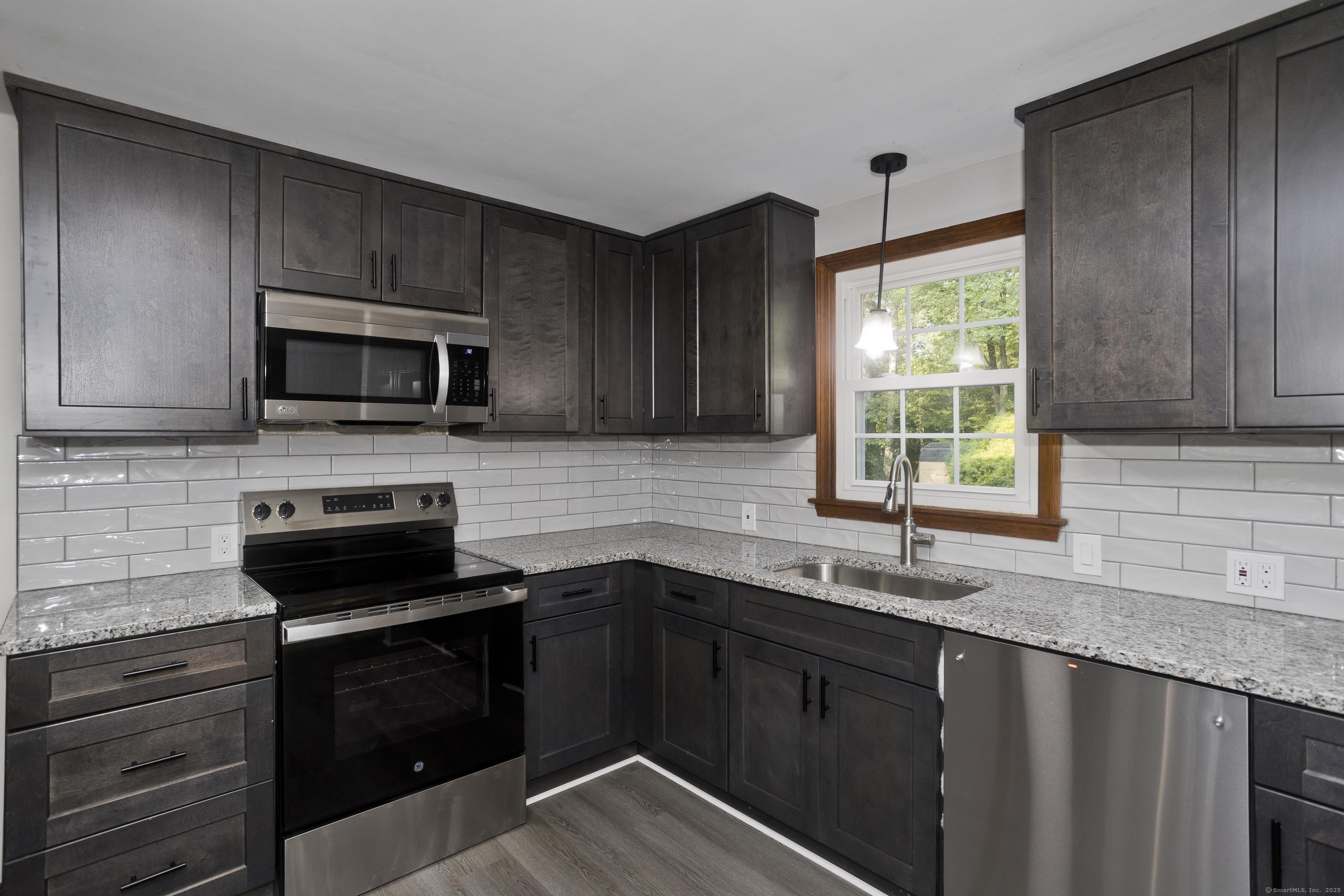 215 Sand Dam Road Thompson, CT 06277 - Photo 8 of 36 a kitchen with a sink stove and microwave