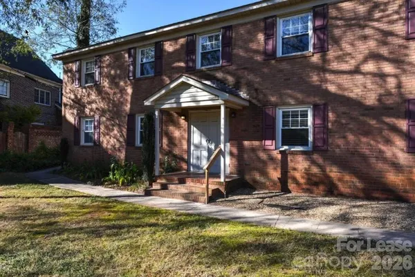 a view of a house with small yard