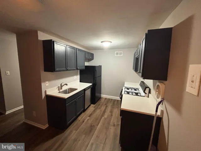 a kitchen with a sink and refrigerator