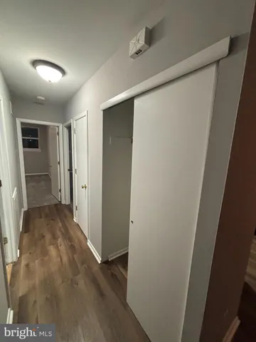 a view of hallway with wooden floor