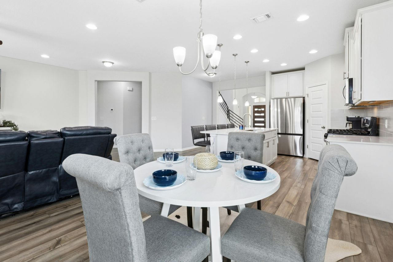 242 Backstays Loop Kyle, TX 78640 - Photo 11 of 36 a view of a dining room with furniture and wooden floor