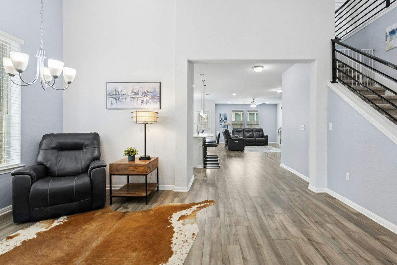 242 Backstays Loop Kyle, TX 78640 - Photo 14 of 36 a living room with furniture and a chandelier