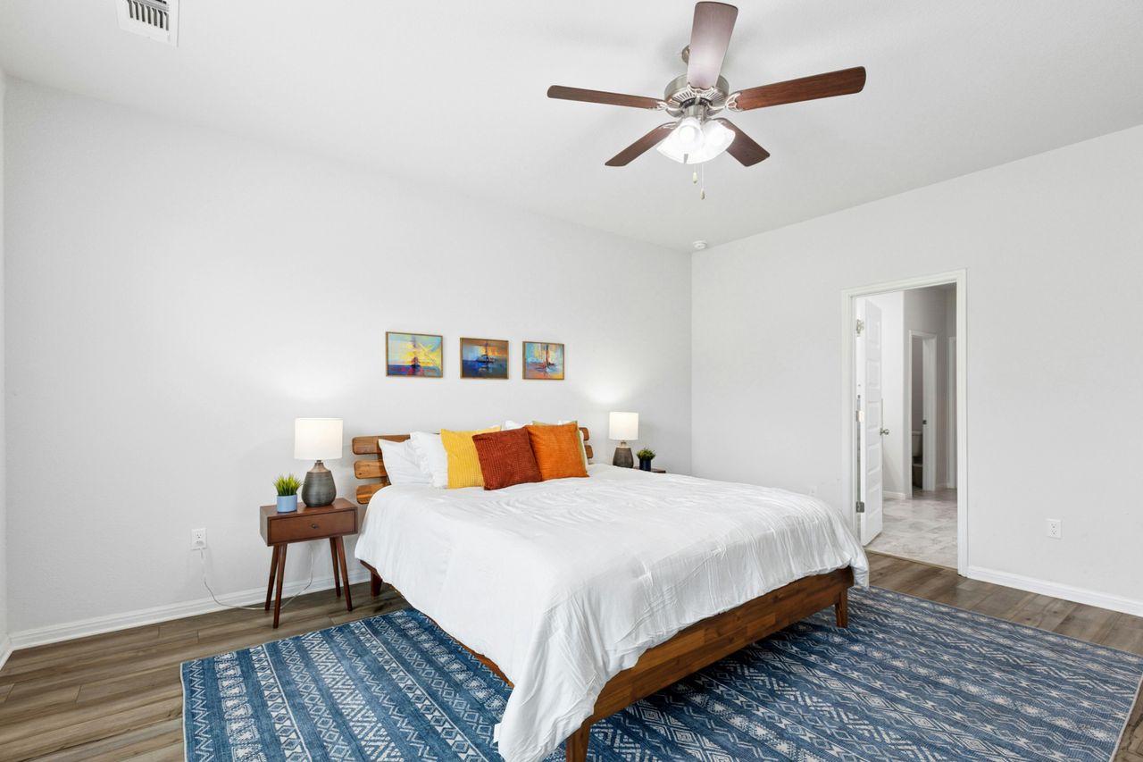 242 Backstays Loop Kyle, TX 78640 - Photo 20 of 36 a bedroom with a bed and a ceiling fan