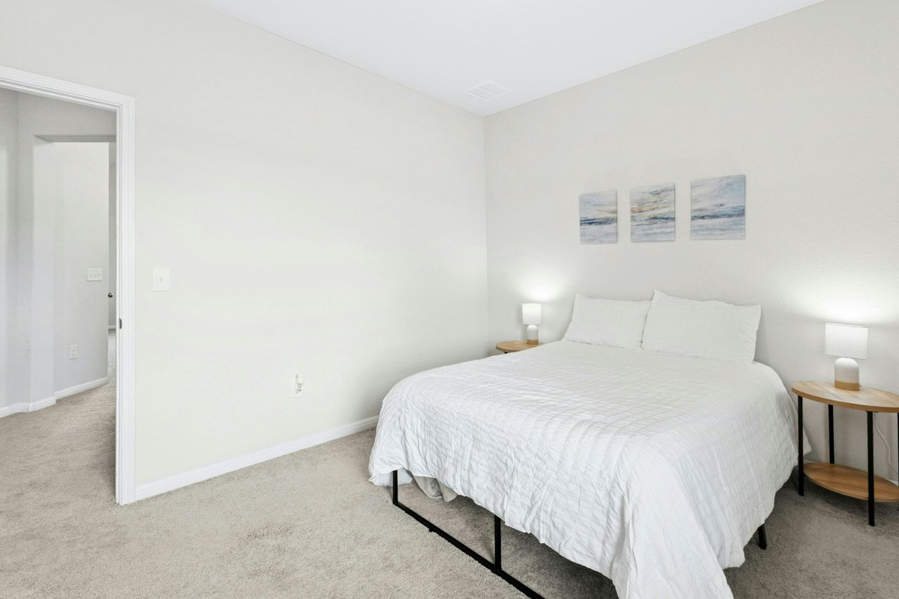 242 Backstays Loop Kyle, TX 78640 - Photo 26 of 36 a bedroom with a bed and a night stand