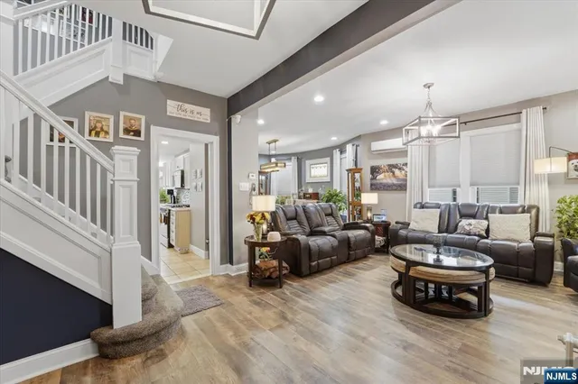 a living room with furniture and a chandelier
