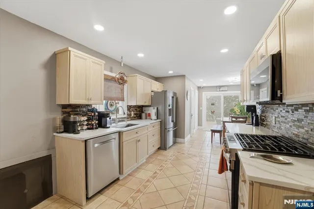 a kitchen with a sink stove and cabinets