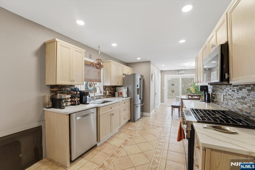 486 Devon Street Kearny, NJ 07032 - Photo 13 of 44 a kitchen with a sink stove and cabinets