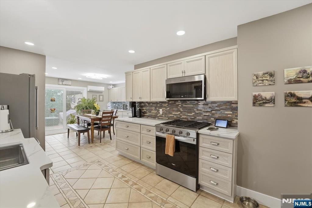 486 Devon Street Kearny, NJ 07032 - Photo 14 of 44 a kitchen with white cabinets and appliances