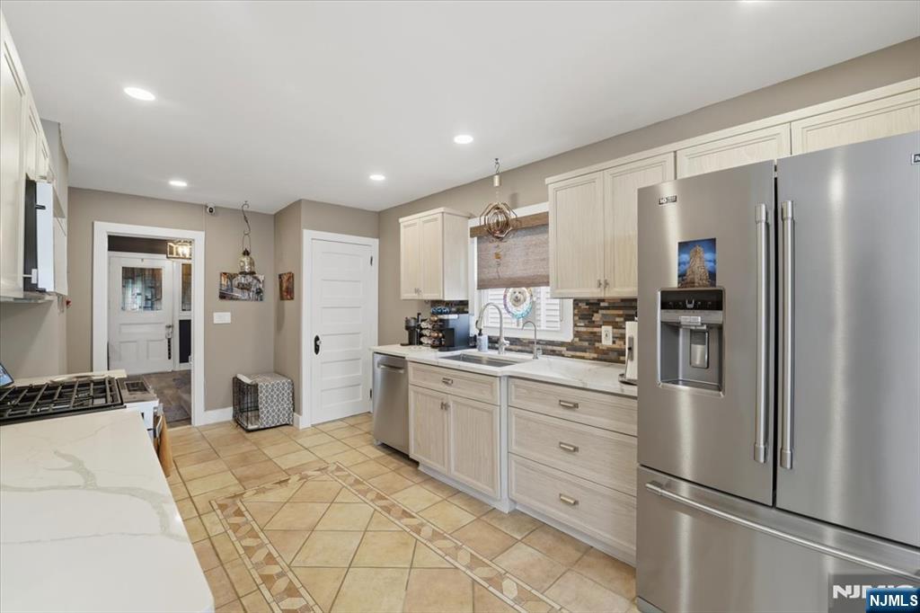 486 Devon Street Kearny, NJ 07032 - Photo 15 of 44 a kitchen with stainless steel appliances granite countertop a refrigerator and a stove top oven