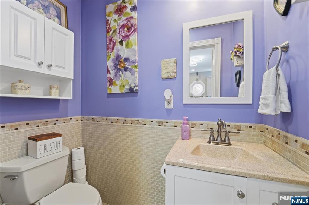 486 Devon Street Kearny, NJ 07032 - Photo 19 of 44 a bathroom with a sink toilet and mirror