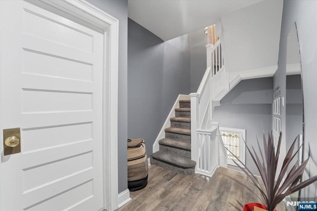 486 Devon Street Kearny, NJ 07032 - Photo 21 of 44 a view of staircase with white walls and a window