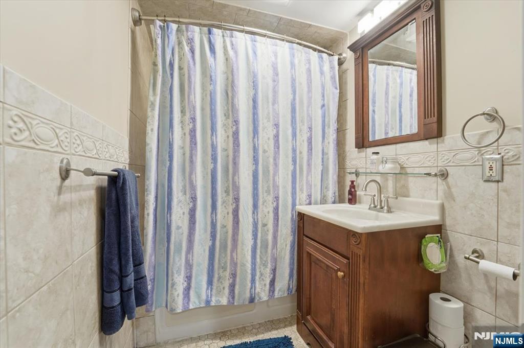 486 Devon Street Kearny, NJ 07032 - Photo 22 of 44 a bathroom with a sink a toilet and a mirror