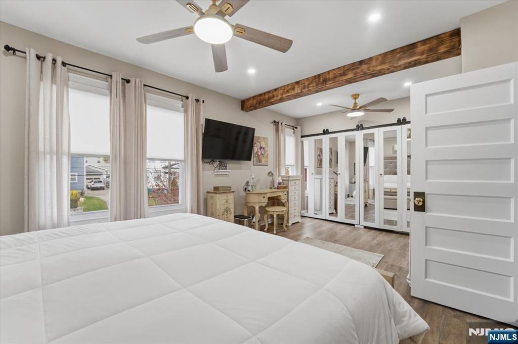 486 Devon Street Kearny, NJ 07032 - Photo 26 of 44 a large bedroom with a bed and a flat screen tv