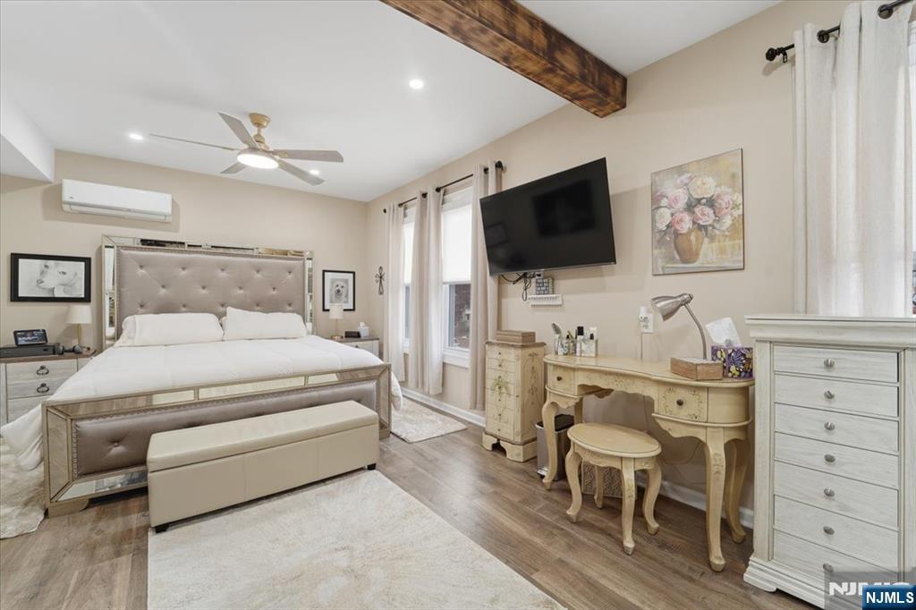 486 Devon Street Kearny, NJ 07032 - Photo 27 of 44 a spacious bedroom with a bed and a flat screen tv