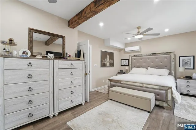 a spacious bedroom with a bed and a dresser