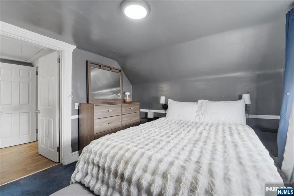 486 Devon Street Kearny, NJ 07032 - Photo 30 of 44 a bed sitting in a bedroom and wooden floor