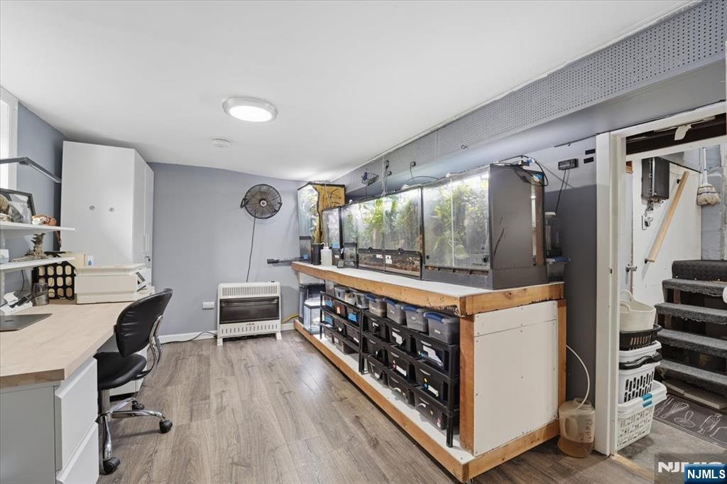 486 Devon Street Kearny, NJ 07032 - Photo 35 of 44 a open kitchen with stainless steel appliances a stove top oven a chimney and a center island