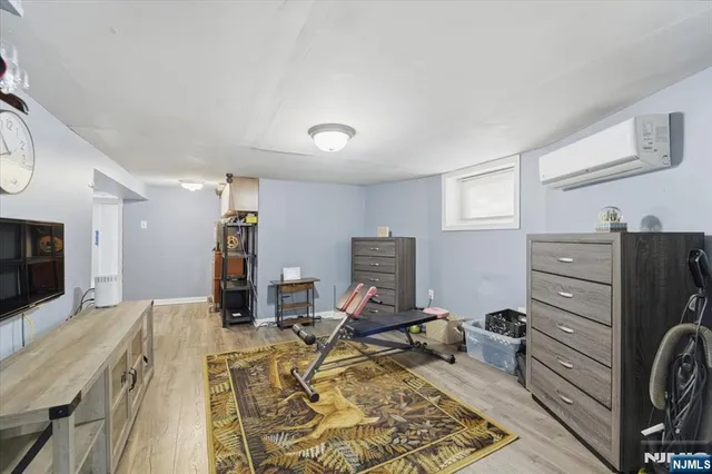 a bed room with a bed window and a television