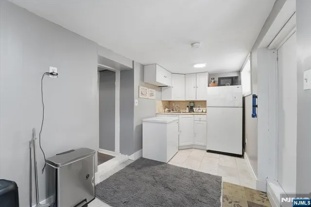a kitchen with cabinets and a refrigerator