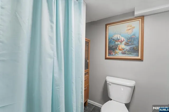 a white toilet sitting next to a small bathroom