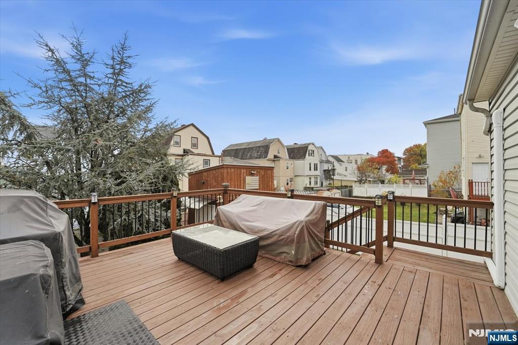 486 Devon Street Kearny, NJ 07032 - Photo 7 of 44 a view of a balcony with two chairs and wooden floor