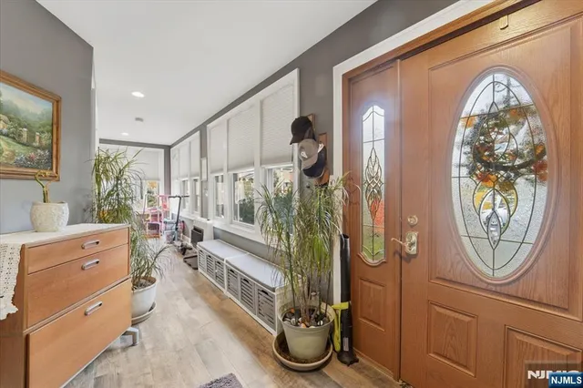 a view of living room and front door with wooden floor