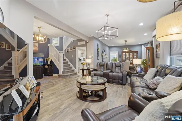 a living room with furniture and a chandelier
