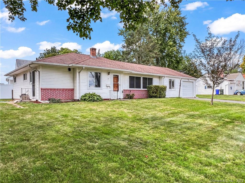 a front view of house with yard and green space