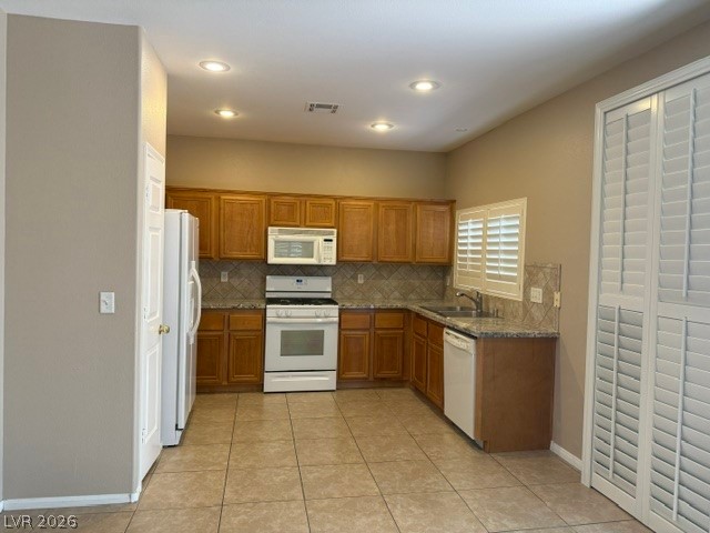 1132 Cathedral Ridge Street Henderson, NV 89052 - Photo 7 of 13 A well-equipped kitchen features tile flooring, wood cabinetry, and a full suite of modern appliances.