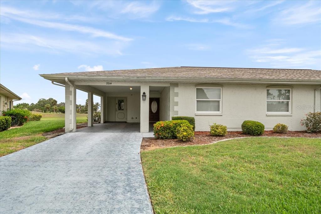 a view of a house with backyard and porch