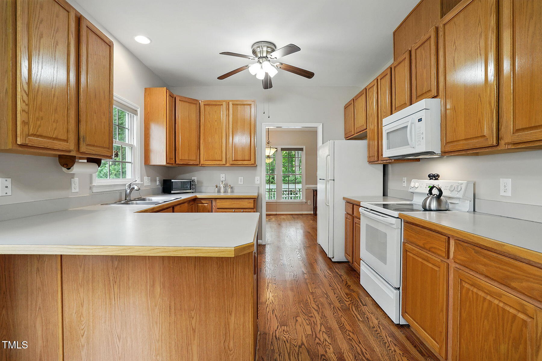 2425 Lemuel Drive Raleigh, NC 27615 - Photo 13 of 36 a kitchen with stainless steel appliances granite countertop wooden cabinets a sink a stove a refrigerator and island
