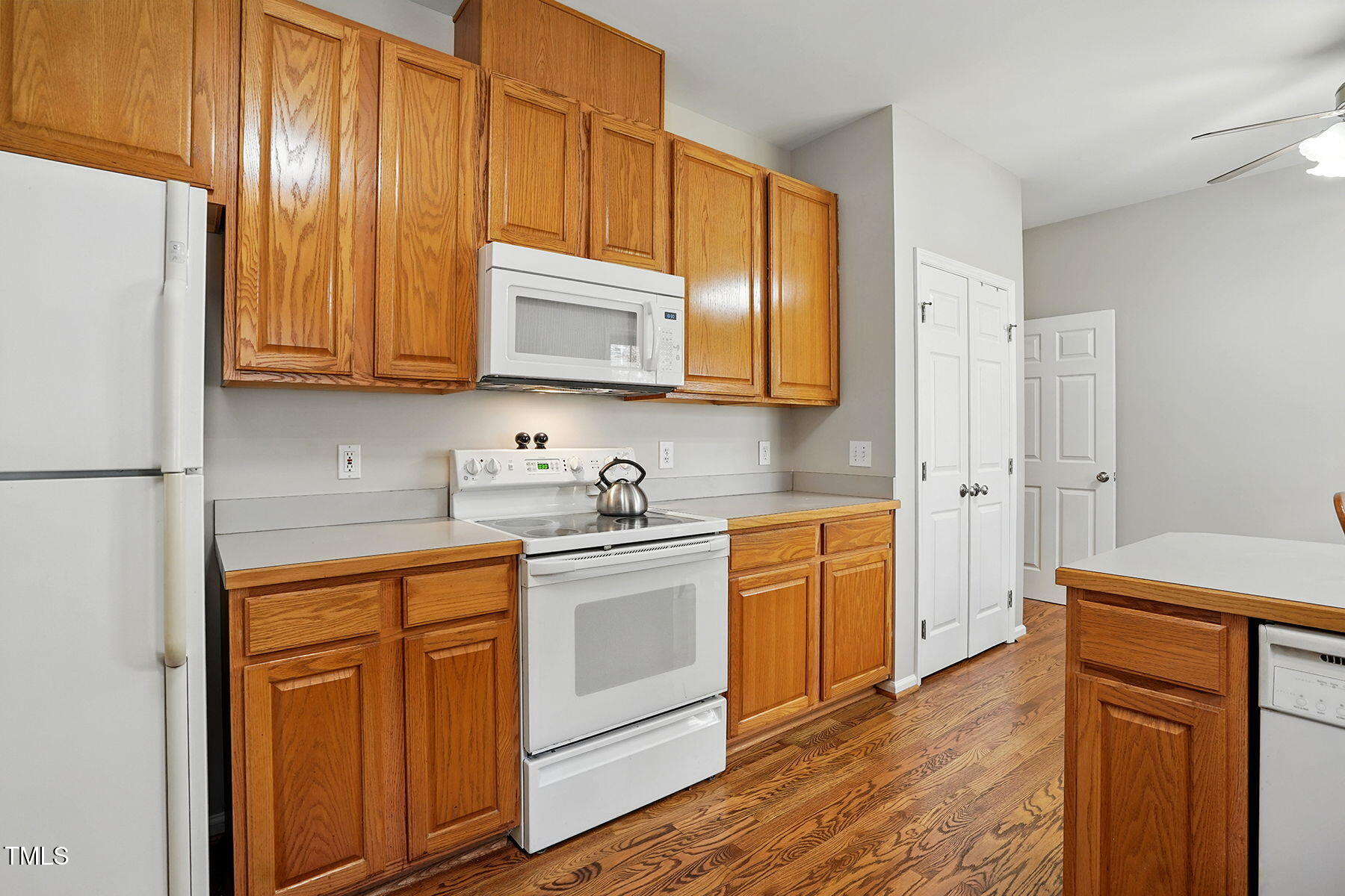 2425 Lemuel Drive Raleigh, NC 27615 - Photo 14 of 36 a kitchen with stainless steel appliances granite countertop a stove a sink dishwasher and a refrigerator with wooden cabinets