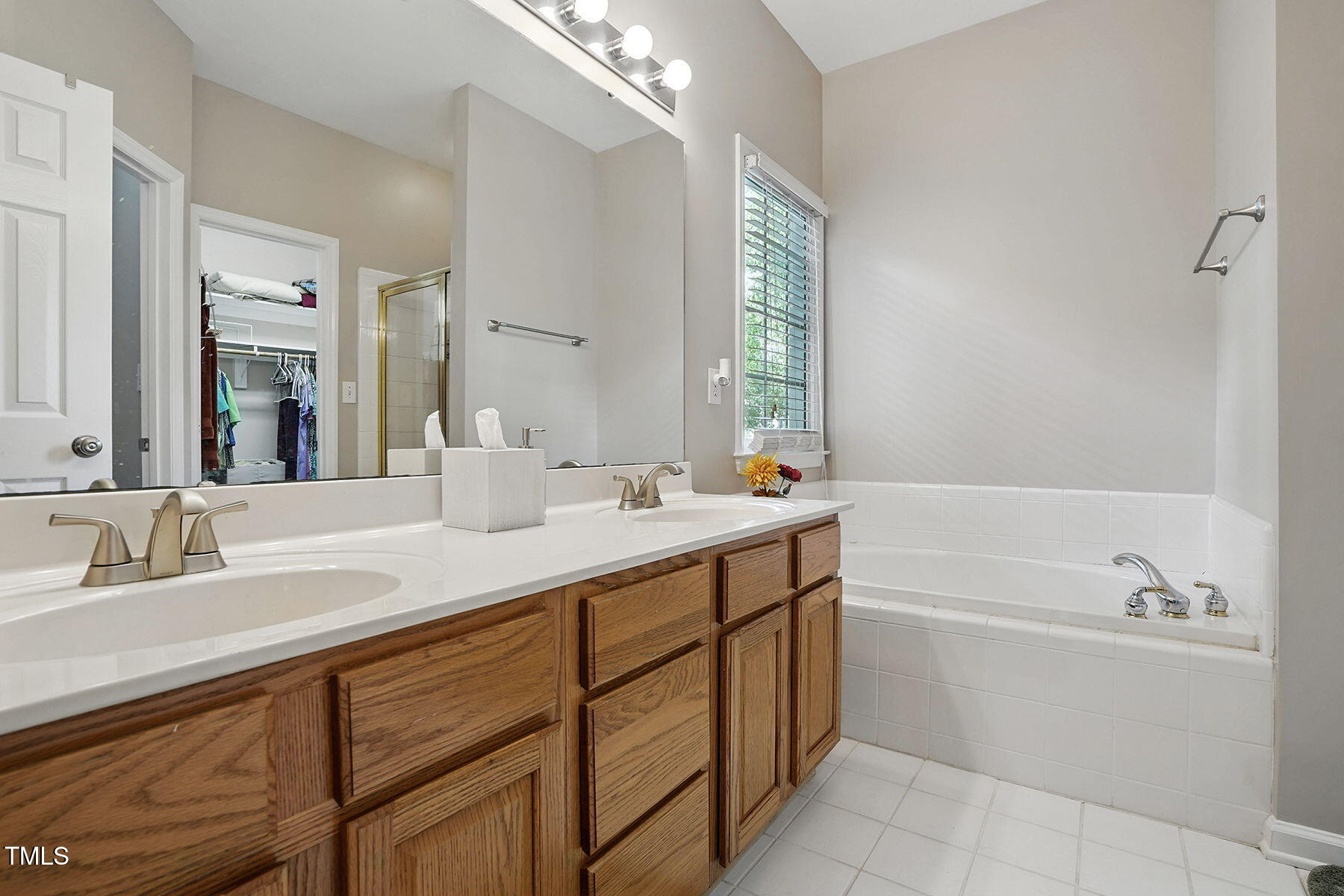 2425 Lemuel Drive Raleigh, NC 27615 - Photo 19 of 36 a bathroom with a tub sink and mirror