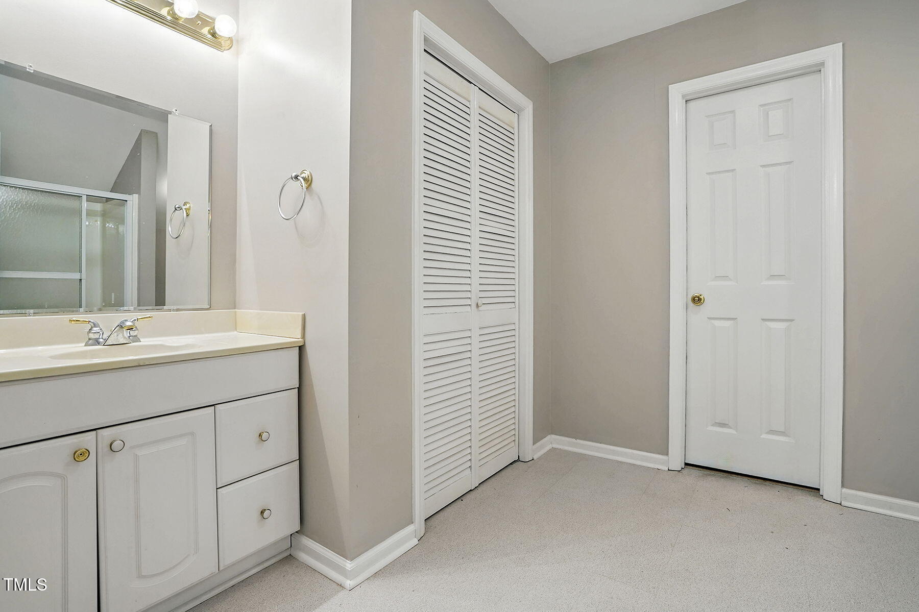 2425 Lemuel Drive Raleigh, NC 27615 - Photo 27 of 36 a bathroom with a sink a vanity and a mirror