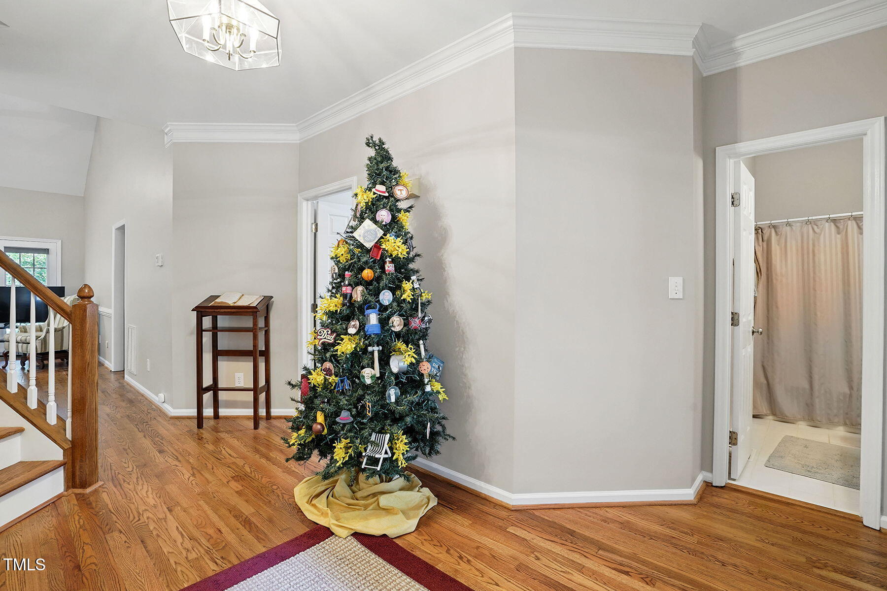 2425 Lemuel Drive Raleigh, NC 27615 - Photo 5 of 36 a view of a hallway with wooden floor and a potted plant