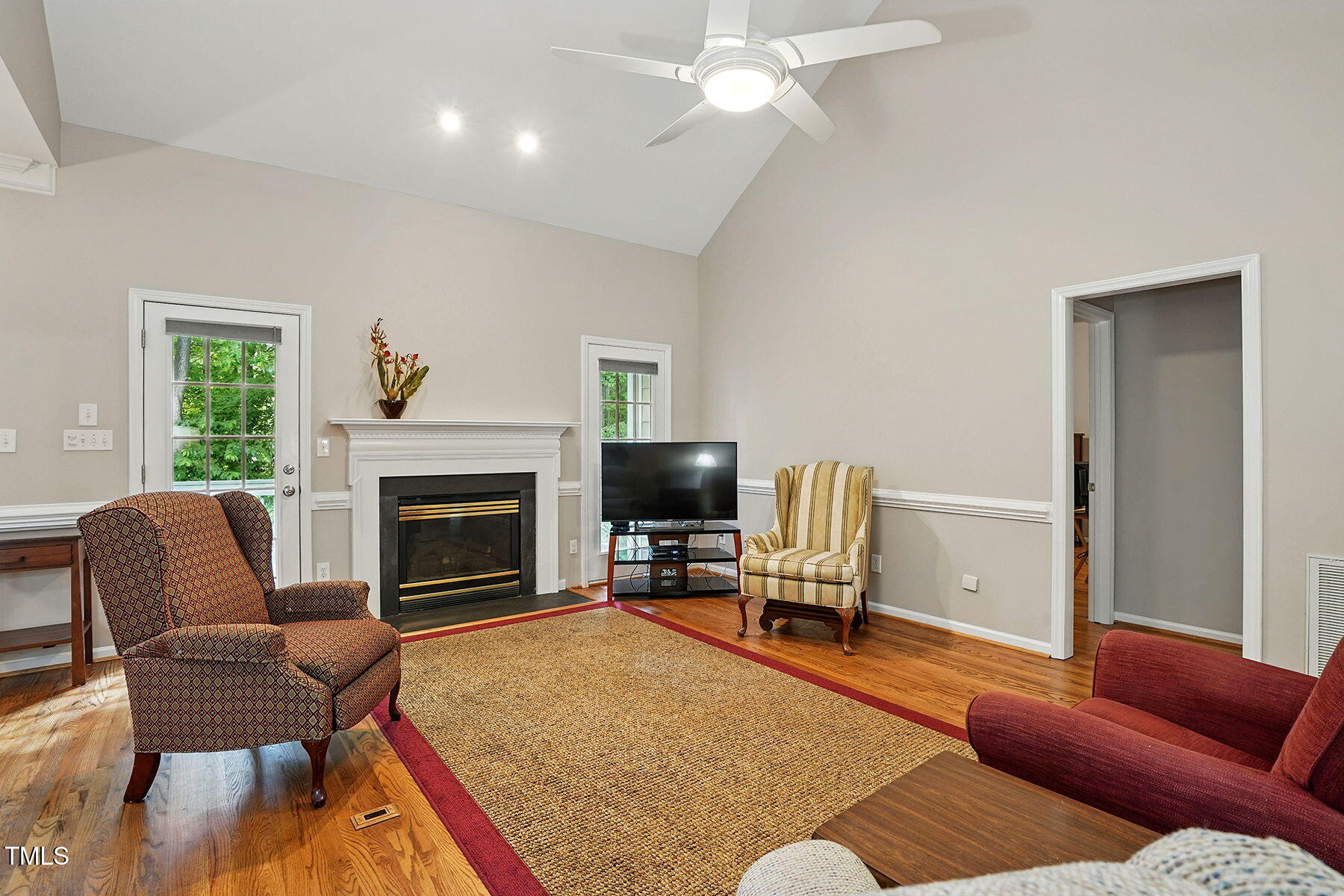 2425 Lemuel Drive Raleigh, NC 27615 - Photo 6 of 36 a living room with furniture a fireplace and a flat screen tv