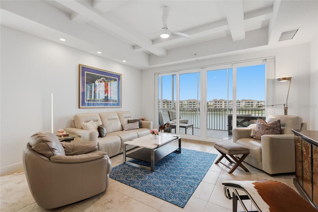 10520 Boardwalk Loop, Unit 301 Bradenton, FL 34202 - Photo 16 of 55 a living room with furniture wooden floor and a table