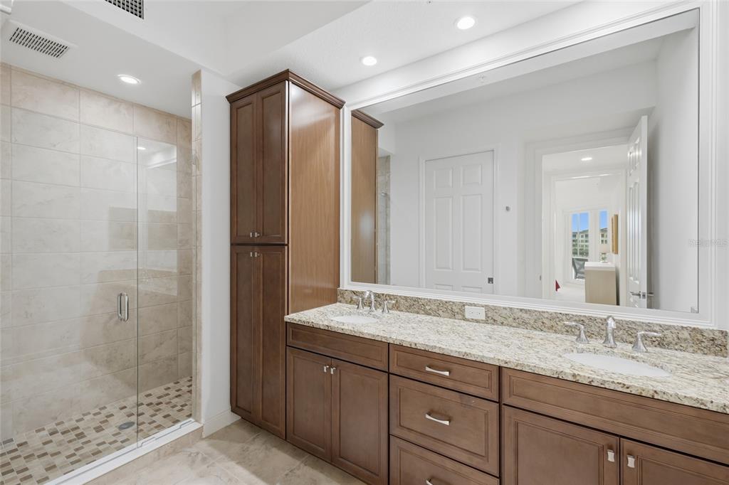 10520 Boardwalk Loop, Unit 301 Bradenton, FL 34202 - Photo 21 of 55 a bathroom with a granite countertop sink mirror and shower