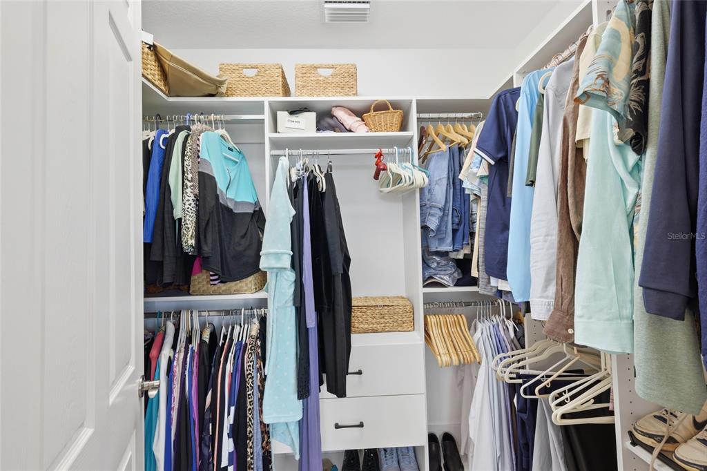 10520 Boardwalk Loop, Unit 301 Bradenton, FL 34202 - Photo 22 of 55 a view of walk in closet with clothes and shoes