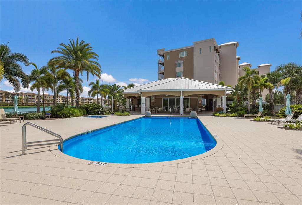 10520 Boardwalk Loop, Unit 301 Bradenton, FL 34202 - Photo 40 of 55 a view of a swimming pool with a patio