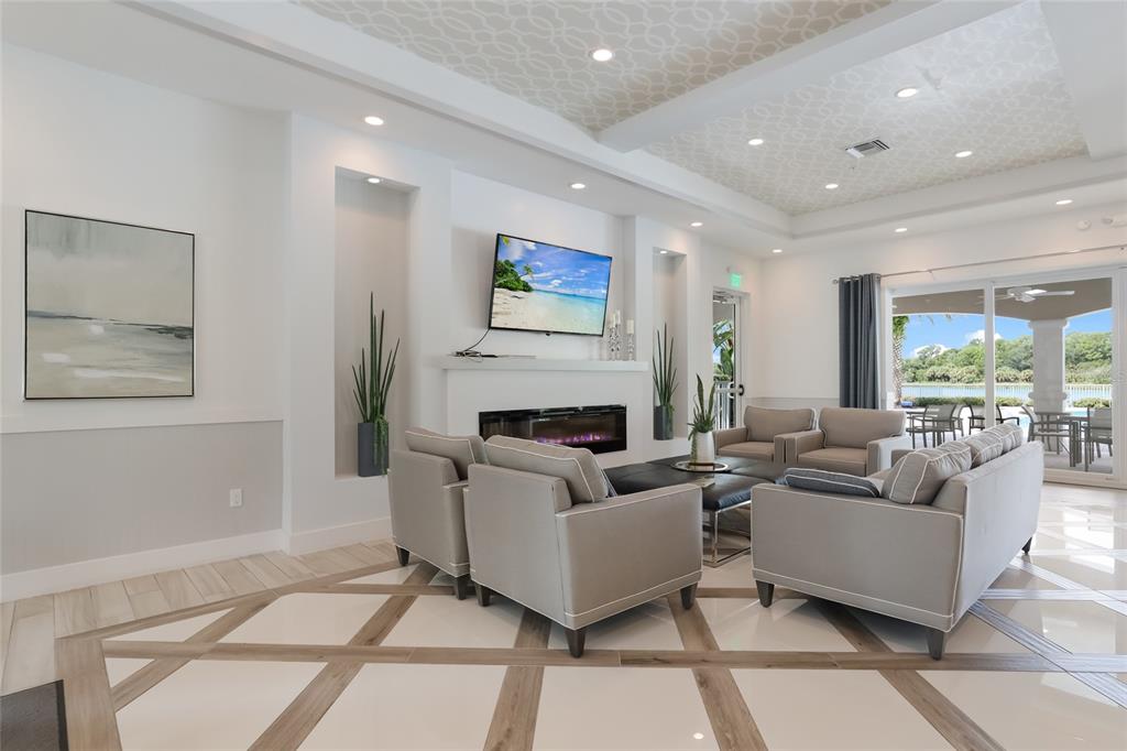 10520 Boardwalk Loop, Unit 301 Bradenton, FL 34202 - Photo 41 of 55 a living room with furniture a large window and a fireplace