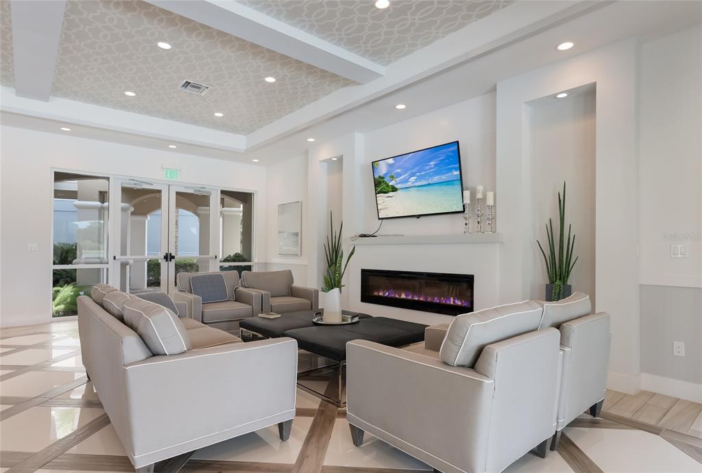 10520 Boardwalk Loop, Unit 301 Bradenton, FL 34202 - Photo 42 of 55 a living room with furniture a fireplace and a floor to ceiling window